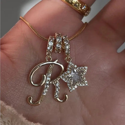 26-letter gold pendant with star decorations